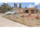 Quaint single-Gathering home with a gravel yard, car in the driveway, and desert landscaping at 604 N Torrey Pines Dr, Las Vegas, NV 89107