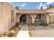 Charming front porch featuring stone column supports, a door wreath and seating for two at 604 N Torrey Pines Dr, Las Vegas, NV 89107