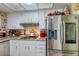 Well-equipped kitchen featuring stainless steel appliances, modern cabinetry, and granite countertops at 604 N Torrey Pines Dr, Las Vegas, NV 89107