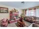 Cozy living room features a decorative brick fireplace and comfortable seating at 604 N Torrey Pines Dr, Las Vegas, NV 89107