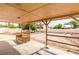 Shaded patio with a bench and views of the spacious backyard, ideal for relaxing or entertaining guests outdoors at 604 N Torrey Pines Dr, Las Vegas, NV 89107