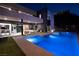 Modern home with an outdoor living area, including a pool, spa, and dining space with city views at 609 Sleeping Dragon Dr, Henderson, NV 89012