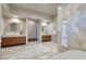 Spa bathroom featuring dual vanities, a soaking tub, and marble accents at 609 Sleeping Dragon Dr, Henderson, NV 89012
