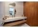 Contemporary powder room featuring wood paneling, a stone countertop, and modern fixtures at 609 Sleeping Dragon Dr, Henderson, NV 89012