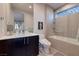 Bathroom featuring a marble sink, a glass shower over tub, and modern fixtures at 609 Sleeping Dragon Dr, Henderson, NV 89012