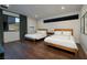 Cozy bedroom features two twin beds, neutral walls, and hardwood floors at 609 Sleeping Dragon Dr, Henderson, NV 89012