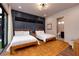 Bright bedroom featuring stylish decor, two beds, textured accent wall, and bathroom access at 609 Sleeping Dragon Dr, Henderson, NV 89012