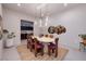 Dining room features an oval table, designer light fixture, purple chairs, and modern decor at 609 Sleeping Dragon Dr, Henderson, NV 89012