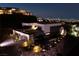 Exterior view of a modern home at night, showcasing the landscaping and city views at 609 Sleeping Dragon Dr, Henderson, NV 89012