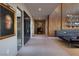 Modern hallway with unique decor, leading to living spaces with wood feature wall and inviting ambiance at 609 Sleeping Dragon Dr, Henderson, NV 89012