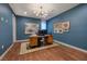 Bright home office features blue walls, modern desk, and decorative lighting at 609 Sleeping Dragon Dr, Henderson, NV 89012