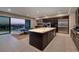 Modern kitchen with stainless steel appliances, a large island, and access to outdoor dining at 609 Sleeping Dragon Dr, Henderson, NV 89012