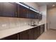 Butler's pantry with custom cabinetry, countertops, and stainless steel sink at 609 Sleeping Dragon Dr, Henderson, NV 89012
