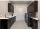 Laundry room featuring front loading washer and dryer with sink and storage cabinets at 609 Sleeping Dragon Dr, Henderson, NV 89012