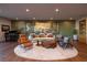 Living room features hardwood floors, modern furniture, and a large area rug at 609 Sleeping Dragon Dr, Henderson, NV 89012