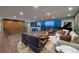 Open living space with hardwood floors, city views, comfortable seating, and a baby grand piano at 609 Sleeping Dragon Dr, Henderson, NV 89012