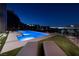 Backyard with a pool and spa offering panoramic city views at night at 609 Sleeping Dragon Dr, Henderson, NV 89012