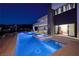 Stunning backyard with a pool, spa, and modern design, perfect for evening relaxation and entertaining at 609 Sleeping Dragon Dr, Henderson, NV 89012