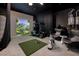 Indoor golf simulation room complete with golf cart, putting green, and comfortable seating at 609 Sleeping Dragon Dr, Henderson, NV 89012