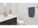 Bathroom featuring a modern sink, toilet, and towel rack at 6618 Palm Branch St, North Las Vegas, NV 89086