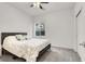 Cozy bedroom with a ceiling fan, a comfortable bed, and natural light from a window at 6618 Palm Branch St, North Las Vegas, NV 89086