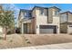 Charming two-story home featuring a two car garage, landscaped front yard, and neutral color palette at 6618 Palm Branch St, North Las Vegas, NV 89086