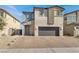 Charming two-story home with a brick paved driveway and a two car garage in a residential neighborhood at 6618 Palm Branch St, North Las Vegas, NV 89086