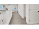 Well-lit hallway with plush gray carpet and bright white trim at 6618 Palm Branch St, North Las Vegas, NV 89086