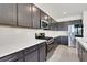 Sleek modern kitchen with granite countertops, stainless steel appliances, and minimalist backsplash at 6618 Palm Branch St, North Las Vegas, NV 89086