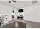 Bright living room features neutral tones, carpet floors, a TV, and a sleek black piano at 6618 Palm Branch St, North Las Vegas, NV 89086
