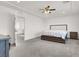 Spacious main bedroom with carpet floors and a ceiling fan at 6618 Palm Branch St, North Las Vegas, NV 89086