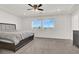 Spacious main bedroom with carpet floors, ceiling fan, and sunny windows with mountain views at 6618 Palm Branch St, North Las Vegas, NV 89086