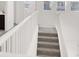 Carpeted staircase with a white railing and lots of natural light at 6618 Palm Branch St, North Las Vegas, NV 89086