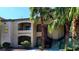 Inviting condo complex featuring lush landscaping and convenient stair access to upper-level units at 7885 W Flamingo Rd # 2003, Las Vegas, NV 89147