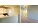 Updated kitchen with modern white appliances, a breakfast bar, and an adjoining living space at 7885 W Flamingo Rd # 2003, Las Vegas, NV 89147