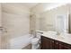 The updated bathroom has a shower/tub combo, modern vanity, and a large mirror at 8541 Highland View Ave, Las Vegas, NV 89145