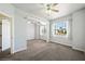 Spacious carpeted bedroom with natural light from multiple windows and a ceiling fan at 8541 Highland View Ave, Las Vegas, NV 89145