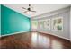 Bright bedroom with wood floors, plantation shutters, and fan for a comfortable and stylish space at 8541 Highland View Ave, Las Vegas, NV 89145