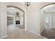 This light-filled entryway has arched doorways, tile flooring, and a fireplace at 8541 Highland View Ave, Las Vegas, NV 89145
