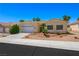 Single-story home with a well-kept lawn, desert landscaping, mature trees, and a two-car garage at 8541 Highland View Ave, Las Vegas, NV 89145
