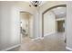 Open hallway featuring archways, tiled floors, and laundry room at 8541 Highland View Ave, Las Vegas, NV 89145