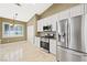 Well-lit kitchen area with stainless steel appliances, tile floors, and classic chandelier at 8541 Highland View Ave, Las Vegas, NV 89145