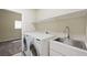 Functional laundry room featuring modern washer, dryer, and utility sink at 8541 Highland View Ave, Las Vegas, NV 89145