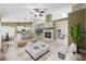 Open-concept living room featuring a fireplace, ceiling fan, and ample natural light at 8541 Highland View Ave, Las Vegas, NV 89145