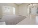 Open-concept living room with arched doorways, tile flooring, plantation shutters, and modern chandelier at 8541 Highland View Ave, Las Vegas, NV 89145