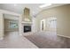 Spacious living room featuring carpet and tile flooring, a skylight, and a fireplace with a tile surround at 8541 Highland View Ave, Las Vegas, NV 89145