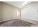 Inviting living room with carpet and tile flooring, neutral paint colors, skylight and an archway at 8541 Highland View Ave, Las Vegas, NV 89145