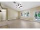 Open living room with tile floors, ceiling fan, and a large window letting in plenty of natural light at 8541 Highland View Ave, Las Vegas, NV 89145