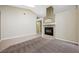 Spacious living room with a tile fireplace, neutral paint, carpet and tile flooring, and a skylight at 8541 Highland View Ave, Las Vegas, NV 89145