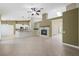 Open-concept living room boasting tile floors, pendant lighting, a ceiling fan, and a modern fireplace at 8541 Highland View Ave, Las Vegas, NV 89145